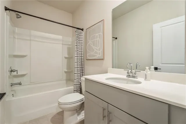 a kitchen with stainless steel appliances a stove a sink dishwasher a refrigerator white cabinets with wooden floor