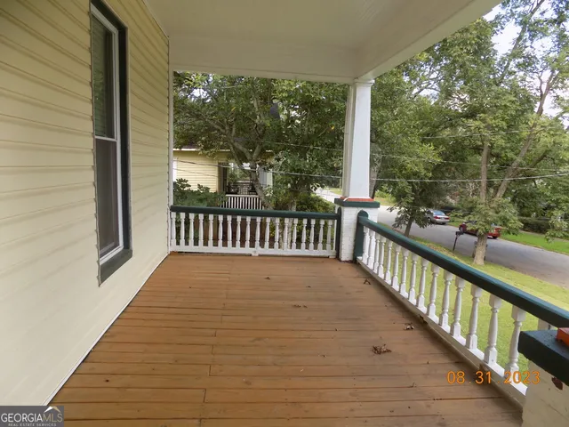 a view of a balcony with wooden floor