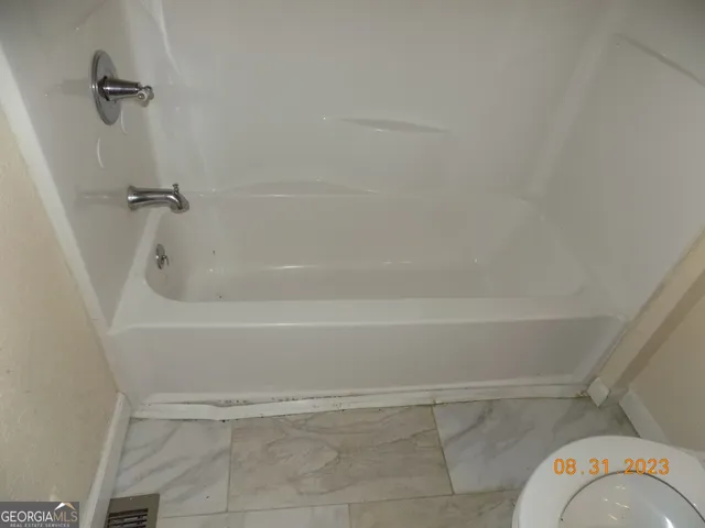 a bath tub sitting next to a shower