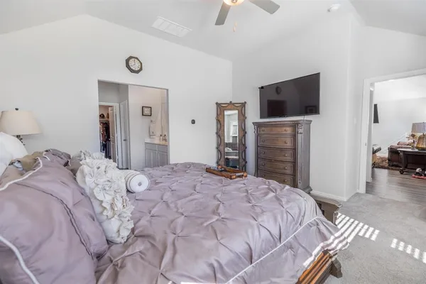 a bedroom with a bed a mirror and a window
