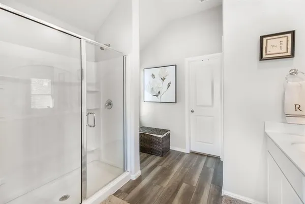 a en suite bathroom with a double vanity sink a mirror and a shower