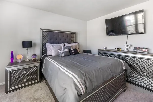 a bed sitting in a bedroom next to a window