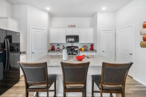 a dining room with furniture and wooden floor