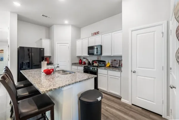 a kitchen with a sink a stove and refrigerator