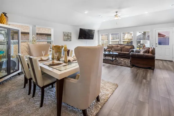 a kitchen with granite countertop kitchen island stainless steel appliances a sink and refrigerator