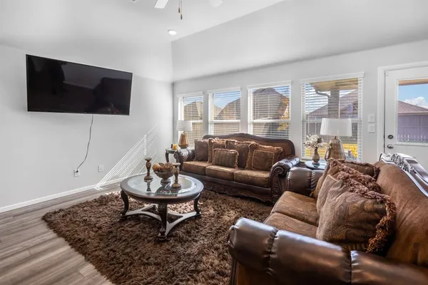 a view of a dining room with furniture and wooden floor