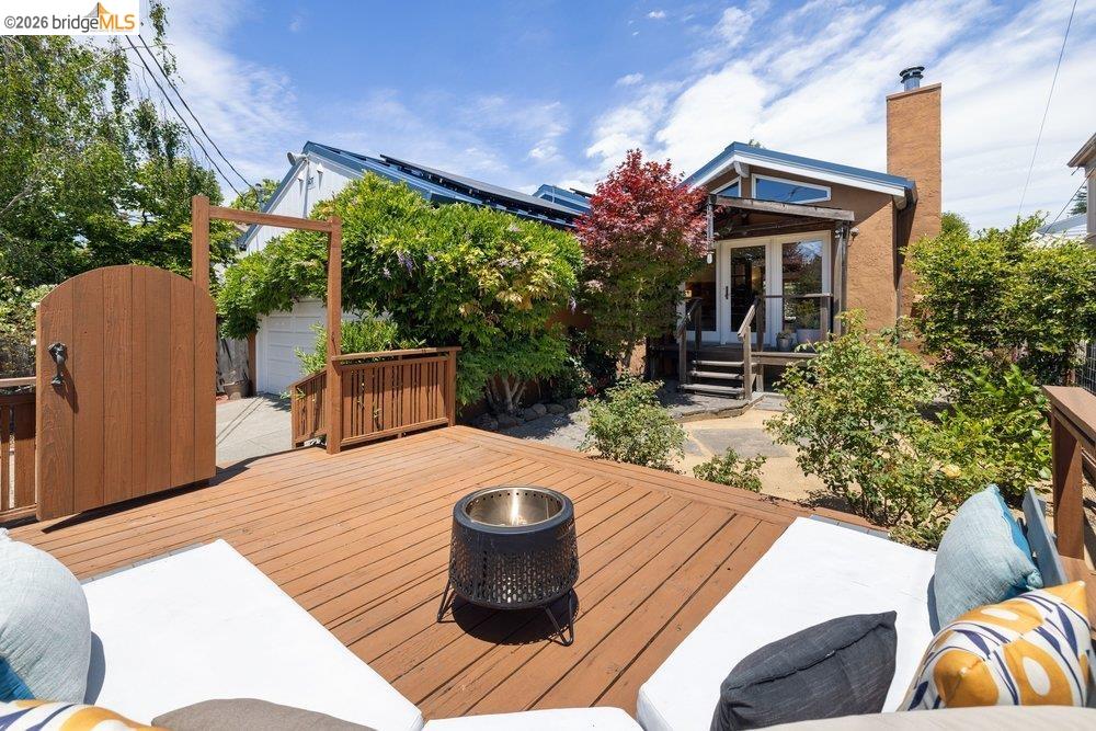 287 Purdue Avenue Kensington, CA 94708 - Photo 8 of 60 Spacious outdoor deck featuring wood decking, a built-in fire pit, and mature perimeter landscaping