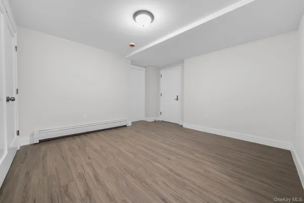 a view of an empty room and wooden floor