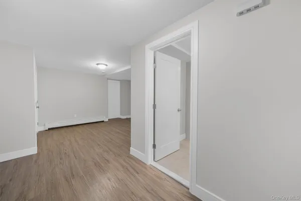 a view of a hallway with wooden floor