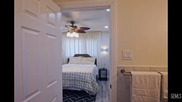 a bedroom with a bed and a chandelier