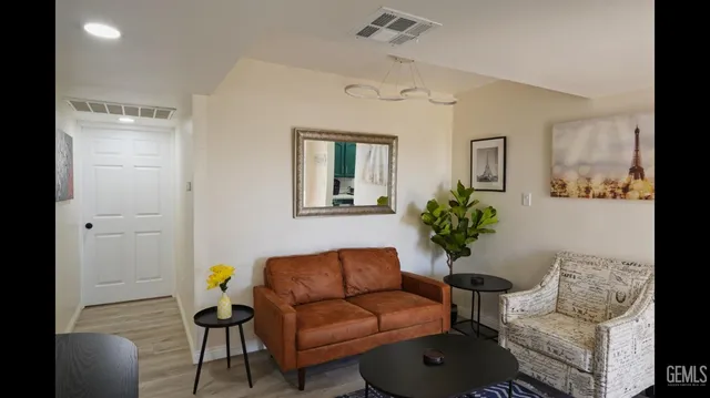 a living room with furniture and wooden floor