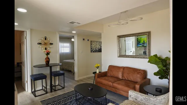 a living room with furniture and a potted plant