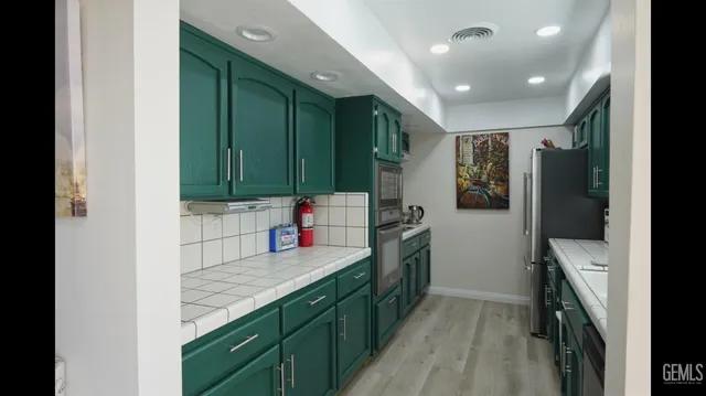a kitchen with a sink stove and cabinets