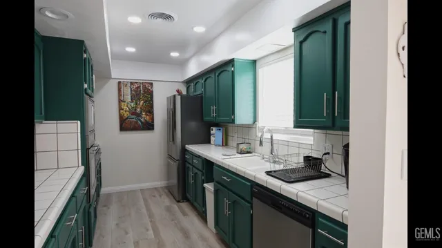 a kitchen with a sink stove and cabinets