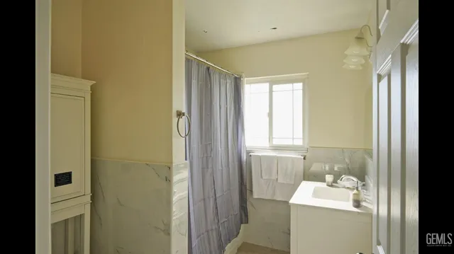 a bathroom with a sink toilet and window