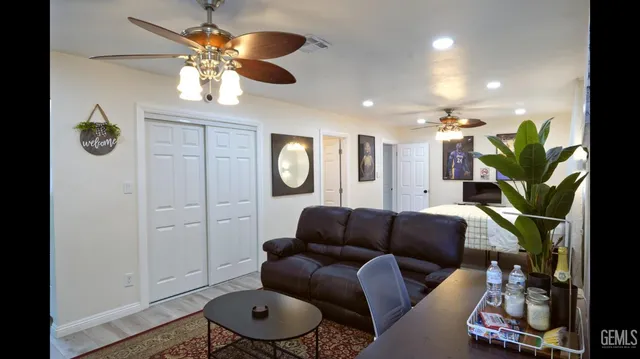 a living room with furniture a chandelier and a rug
