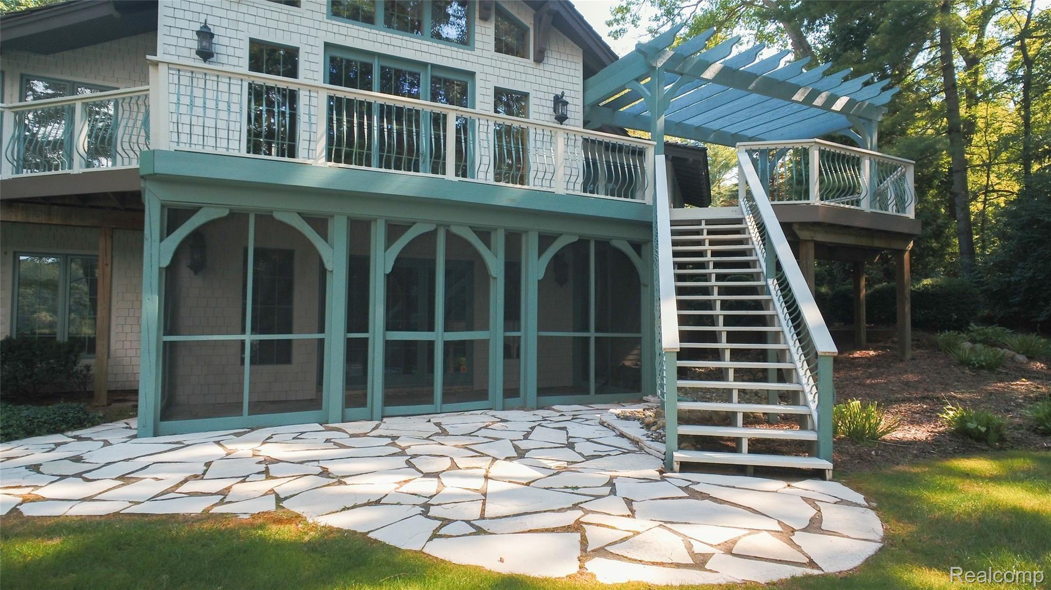 1515 Addaleen Road Highland, MI 48357 - Photo 20 of 48 Deck has access to Lower Level Stone Patio and Screened in Veranda