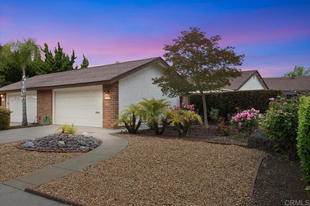 a front view of a house with a yard and a garage