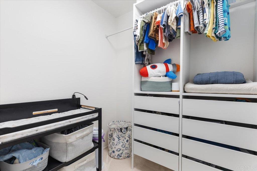 2150 Pepper Tree Place Escondido, CA 92026 - Photo 17 of 48 a view of walk in closet with clothes and shoes