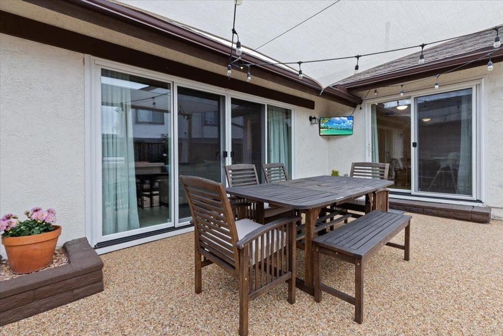 2150 Pepper Tree Place Escondido, CA 92026 - Photo 18 of 48 a backyard of a house with wooden table and chairs
