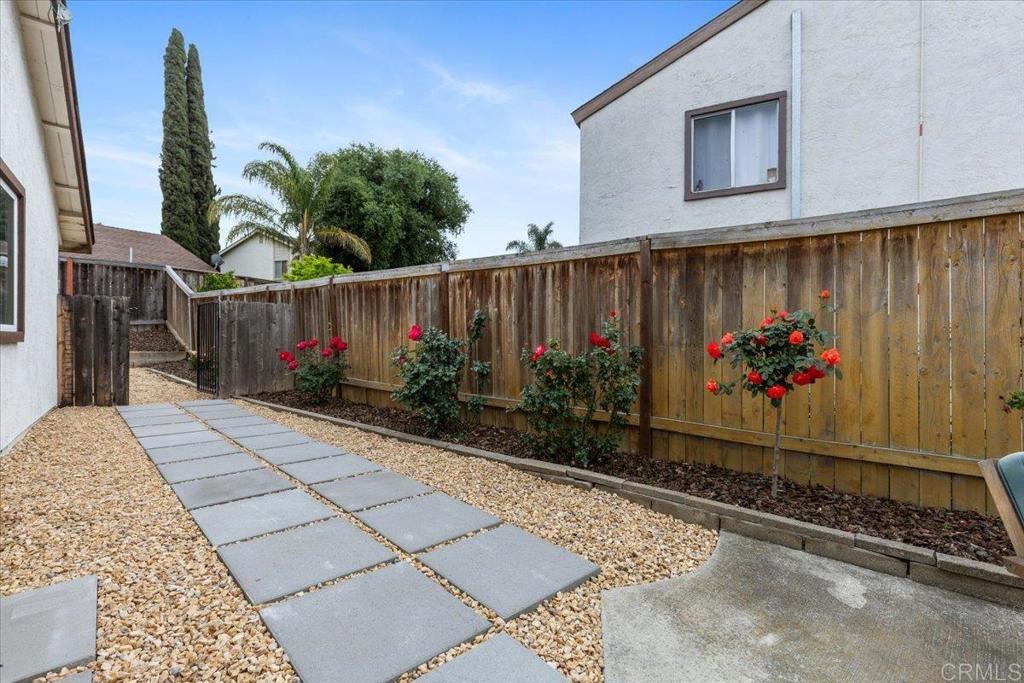 2150 Pepper Tree Place Escondido, CA 92026 - Photo 21 of 48 a garden with flowers in front of it