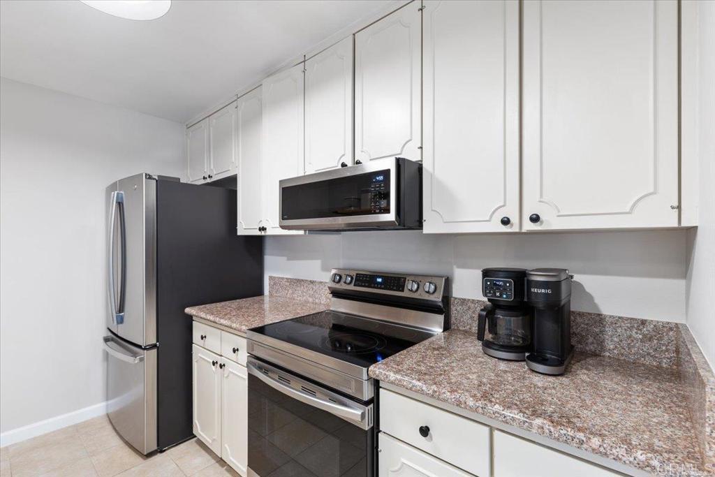 2150 Pepper Tree Place Escondido, CA 92026 - Photo 8 of 48 a kitchen with appliances a sink and cabinets