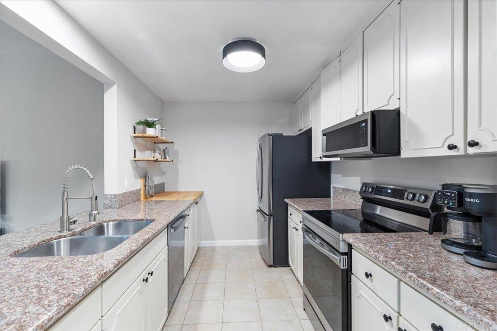 2150 Pepper Tree Place Escondido, CA 92026 - Photo 9 of 48 a kitchen with stainless steel appliances granite countertop a sink stove and refrigerator