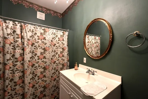 a bedroom with a bed a fireplace and a large window