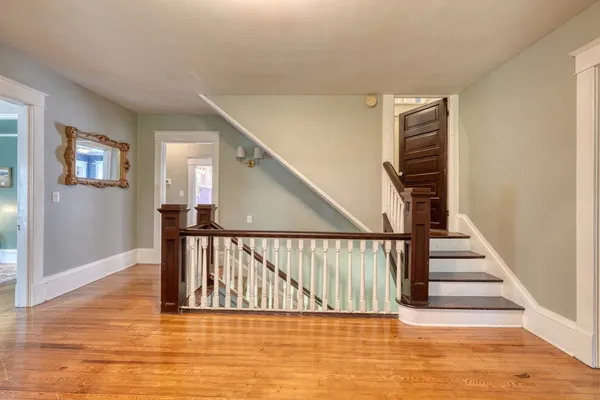 a bedroom with a bed ceiling fan and a window