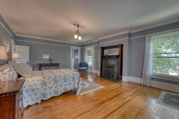 a bedroom with a bed and a mirror