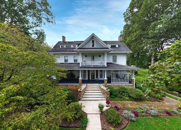 a front view of a house with a garden and plants