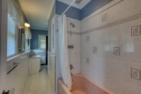 an empty room with windows and cabinet