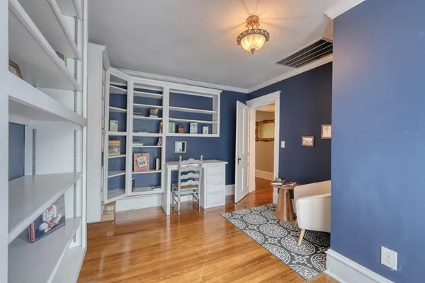 a view of a deck with a bench and floor to ceiling window