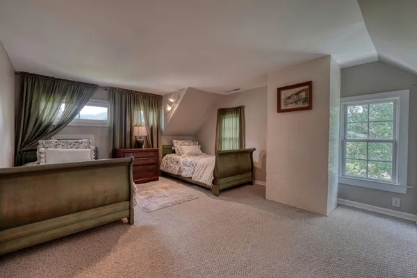 a front view of a house with a yard and potted plants