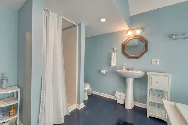 a view of a chair and table in backyard of the house