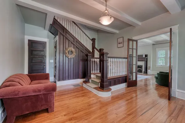 a living room with furniture a wooden floor and a fireplace