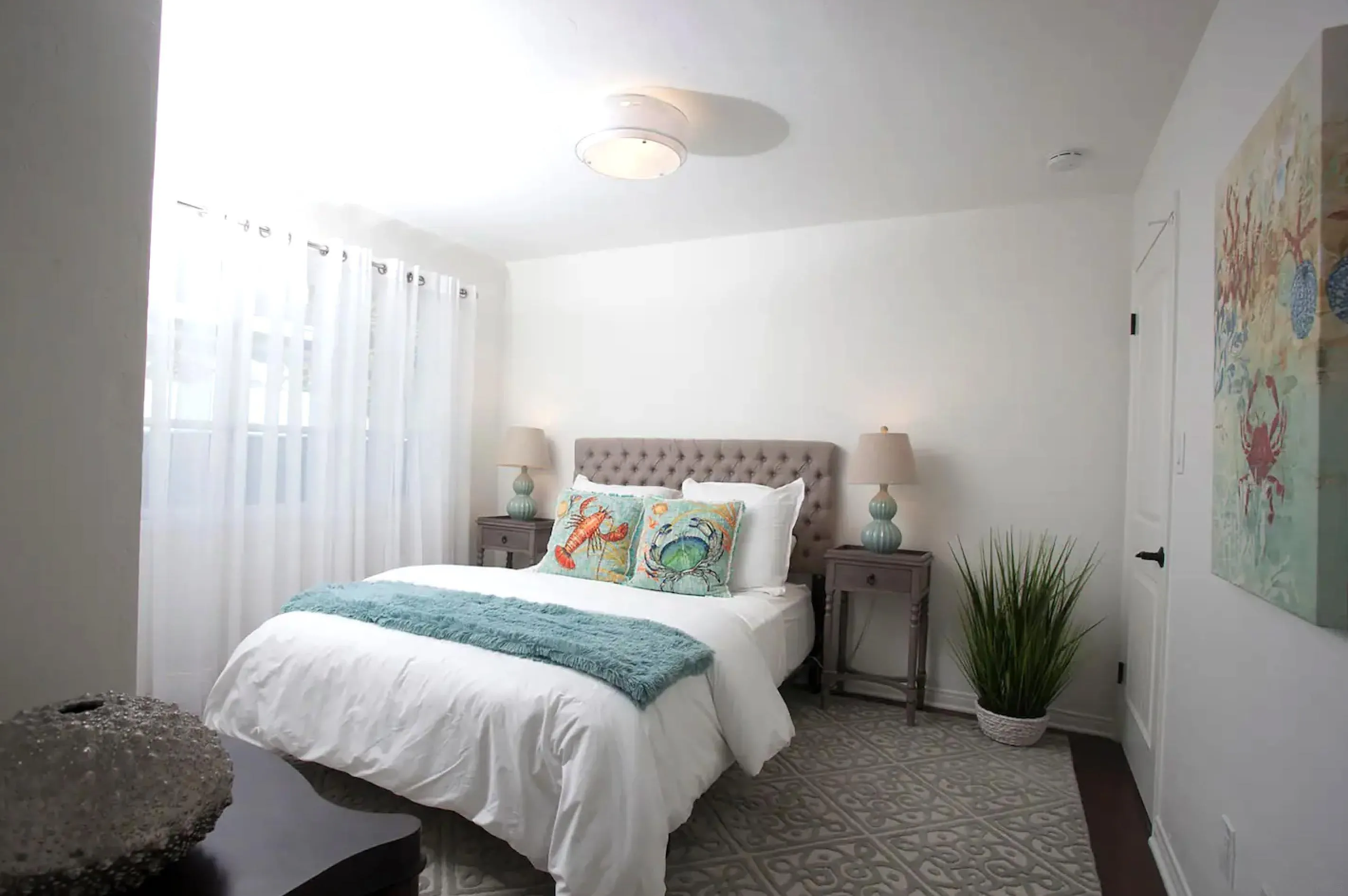 8381 El Paseo Grande La Jolla, CA 92037 - Photo 14 of 21 a bedroom with a bed and a potted plant