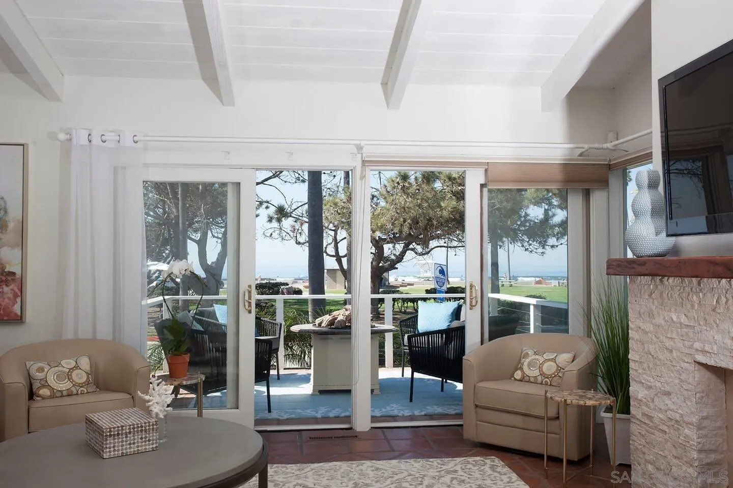 8381 El Paseo Grande La Jolla, CA 92037 - Photo 3 of 21 a living room with furniture and a floor to ceiling window