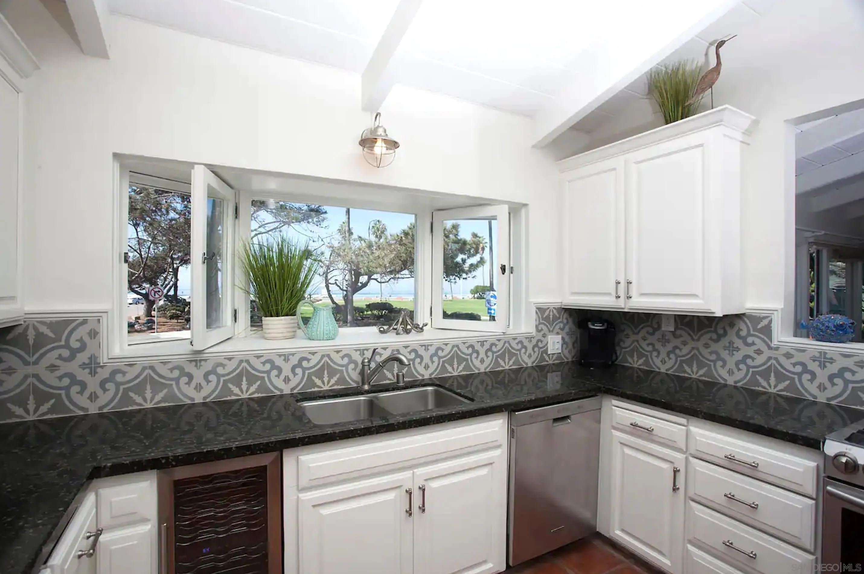 8381 El Paseo Grande La Jolla, CA 92037 - Photo 4 of 21 a kitchen with granite countertop white cabinets and window