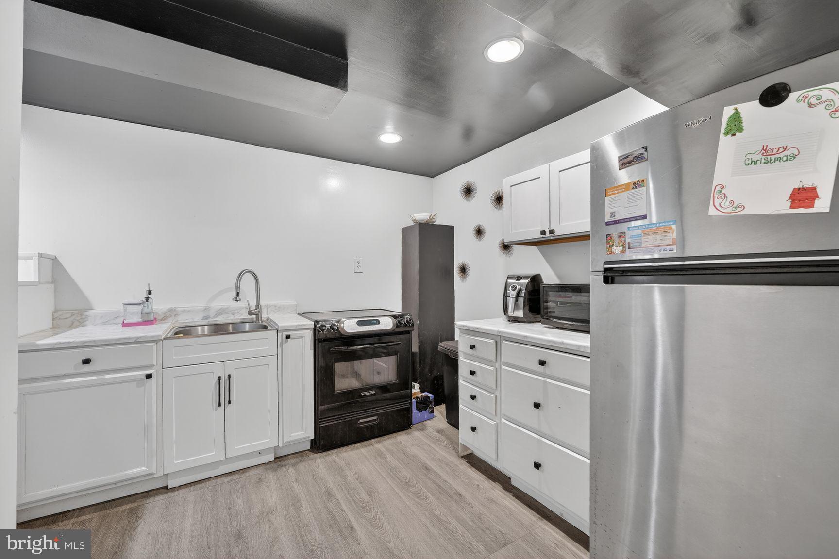 1104 Caddington Avenue Silver Spring, MD 20901 - Photo 25 of 35 a kitchen with stainless steel appliances a sink and cabinets