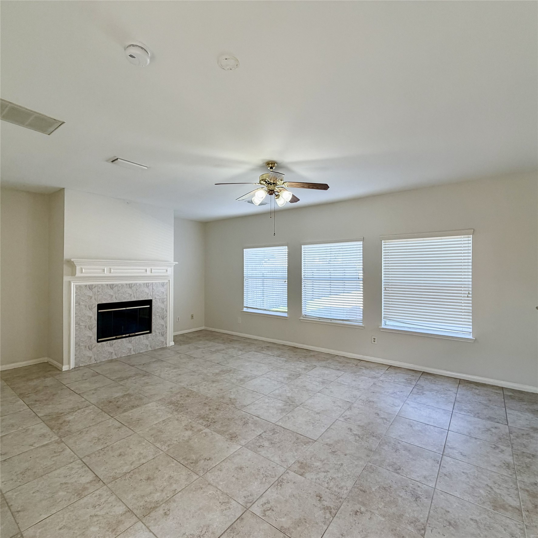 12219 Winderwick Lane Houston, TX 77066 - Photo 11 of 36 a view of livingroom with an empty space fireplace and a window