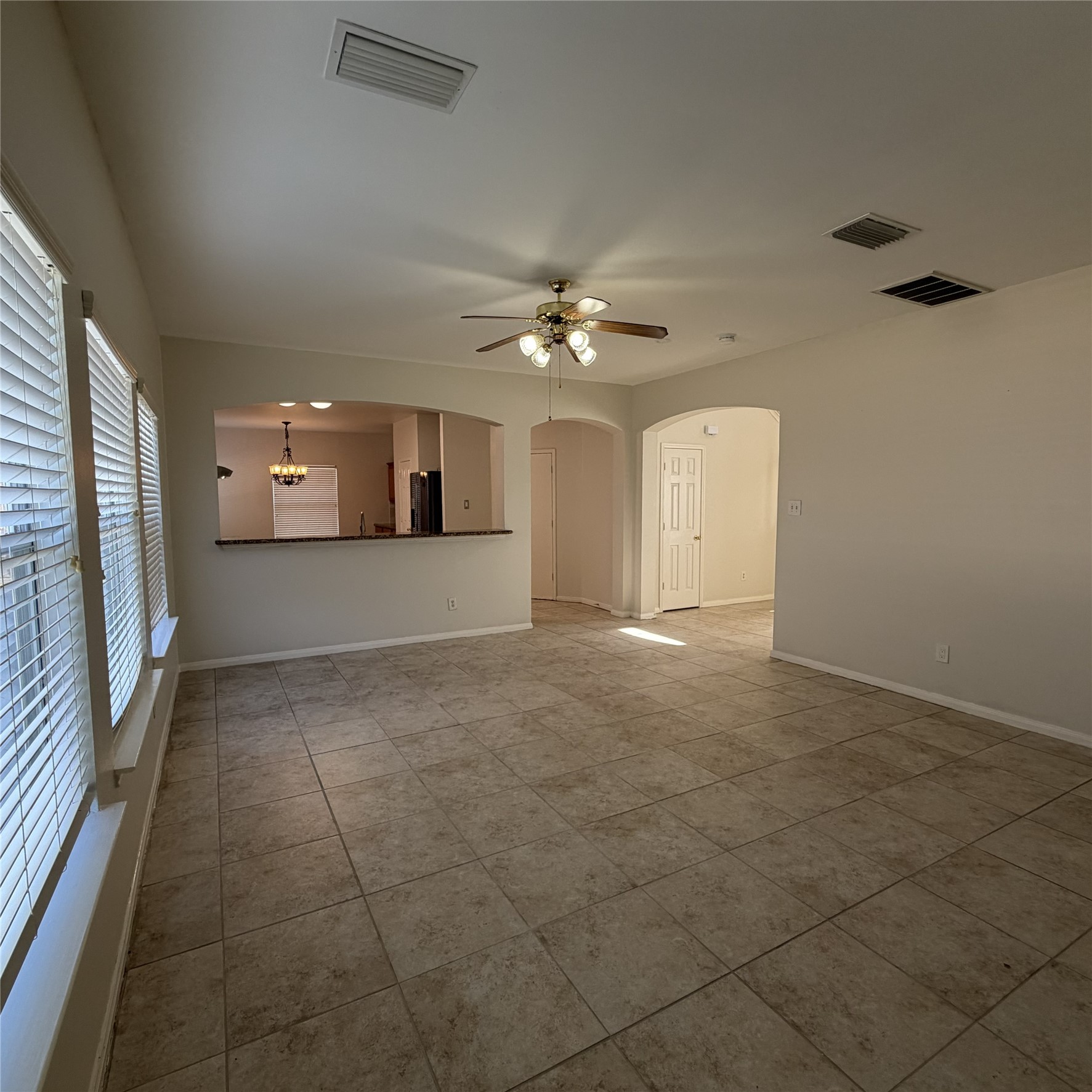 12219 Winderwick Lane Houston, TX 77066 - Photo 12 of 36 a view of a livingroom with a ceiling fan and window