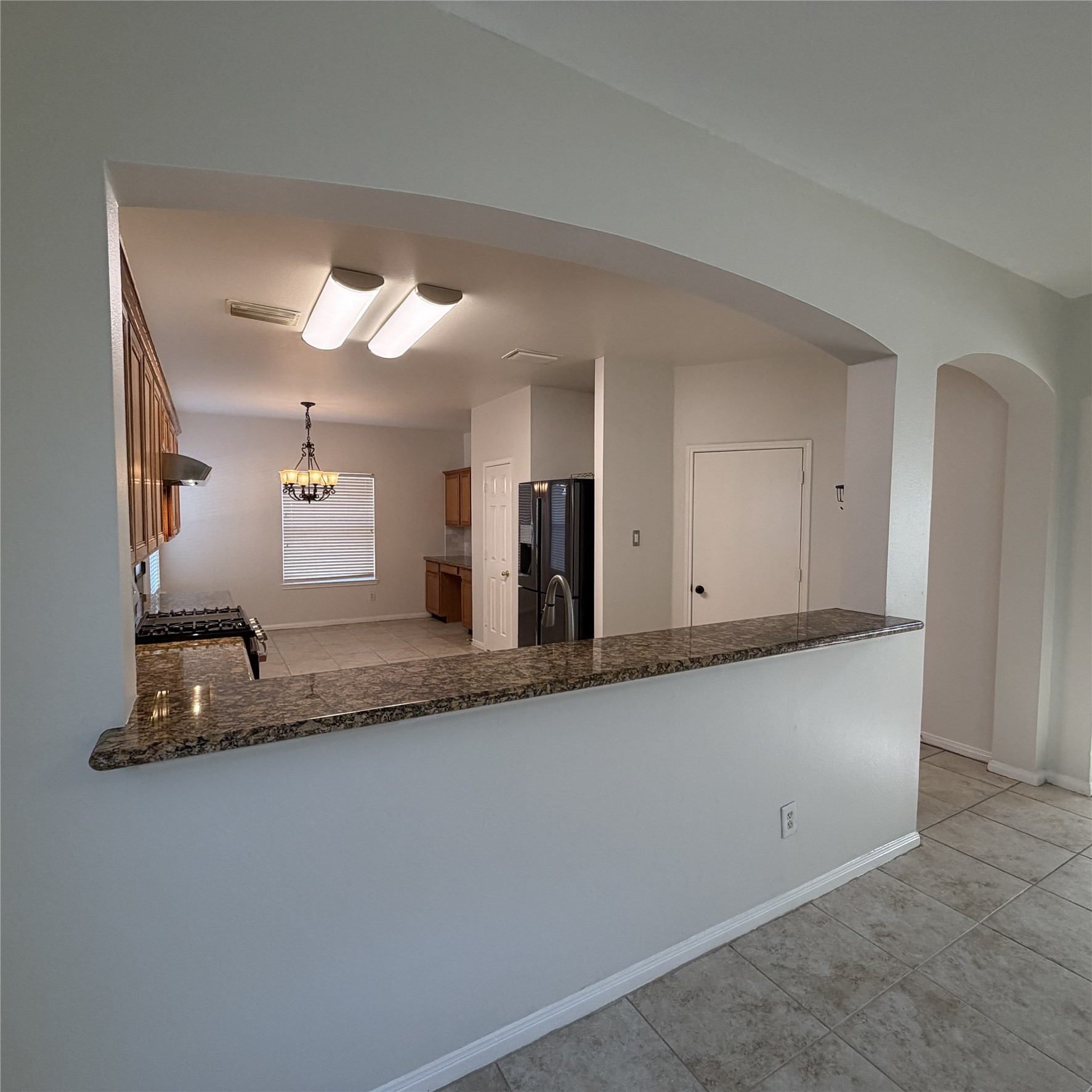 12219 Winderwick Lane Houston, TX 77066 - Photo 13 of 36 a view of a kitchen with granite countertop cabinets and a sink