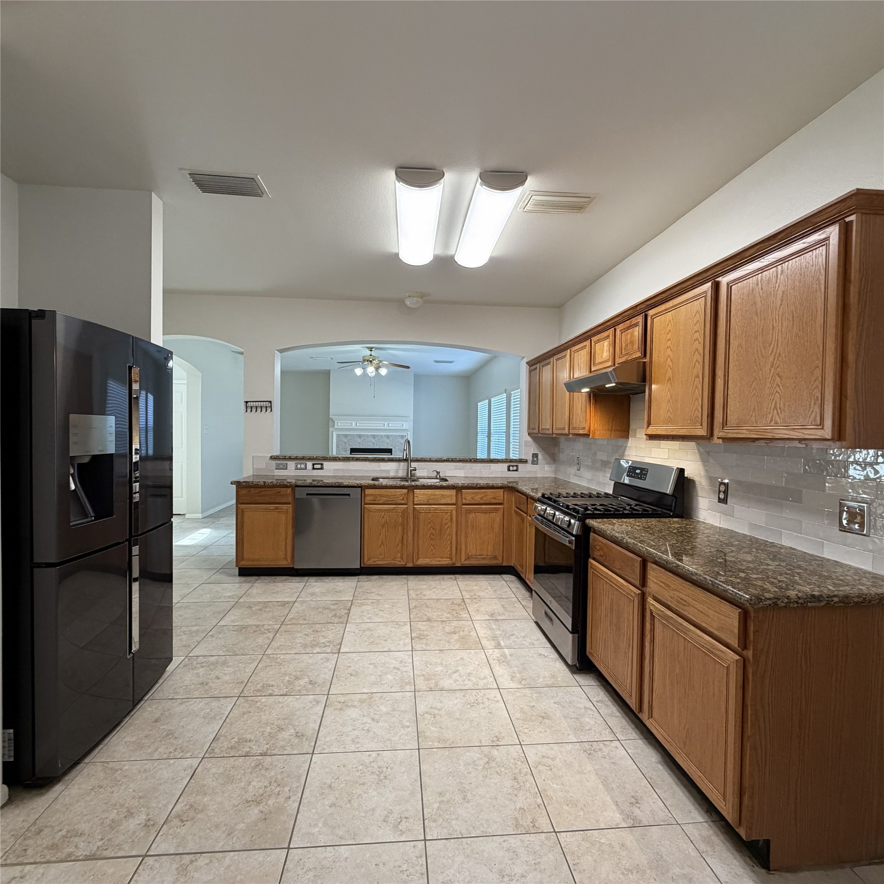 12219 Winderwick Lane Houston, TX 77066 - Photo 15 of 36 a large kitchen with a large counter top stainless steel appliances and cabinets