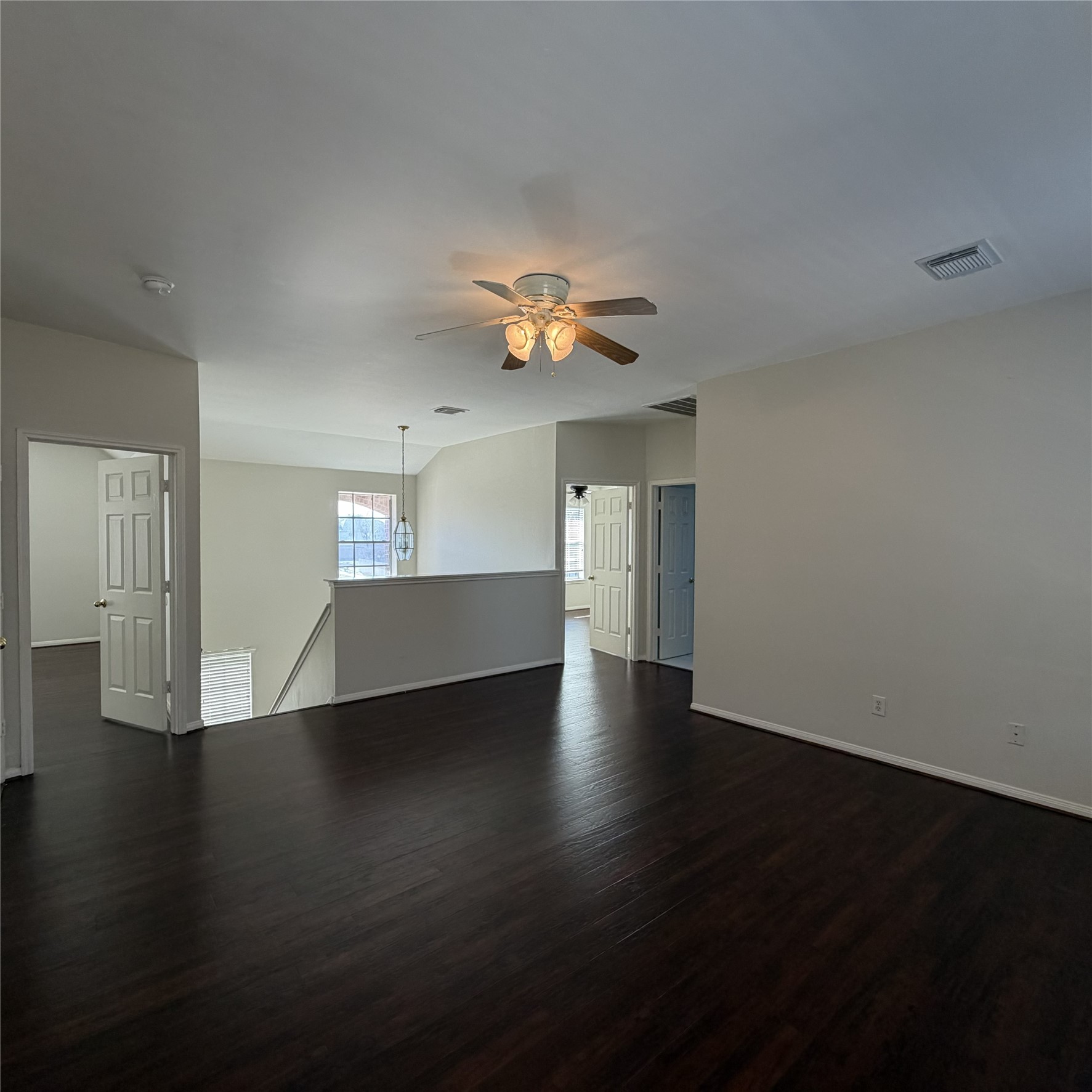 12219 Winderwick Lane Houston, TX 77066 - Photo 19 of 36 a view of an empty room with wooden floor and a ceiling fan