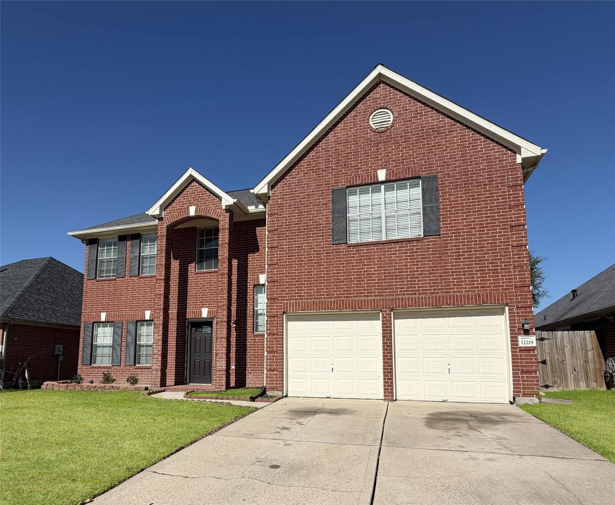 12219 Winderwick Lane Houston, TX 77066 - Photo 2 of 36 a front view of a house with a yard