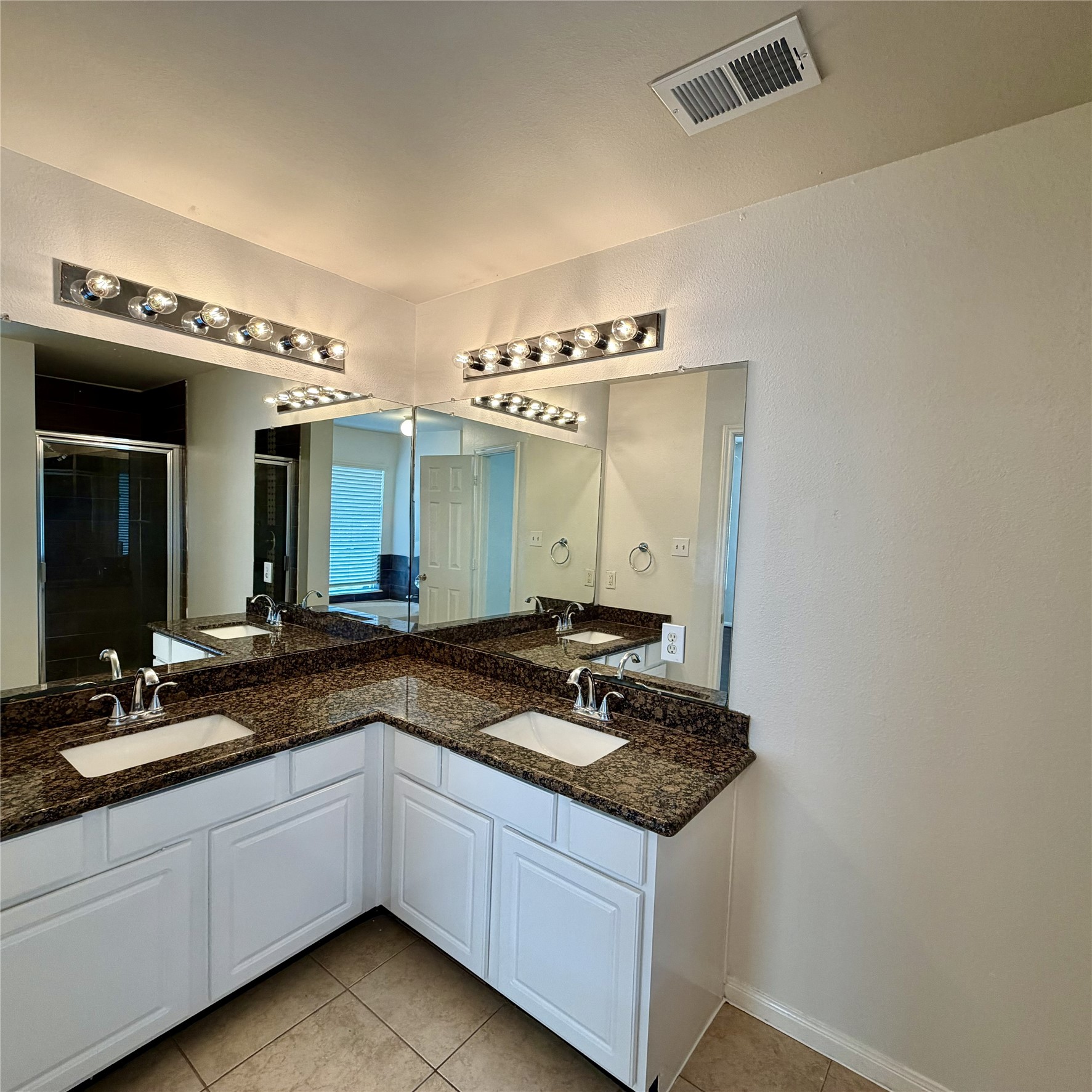 12219 Winderwick Lane Houston, TX 77066 - Photo 24 of 36 a bathroom with a granite countertop sink and a mirror