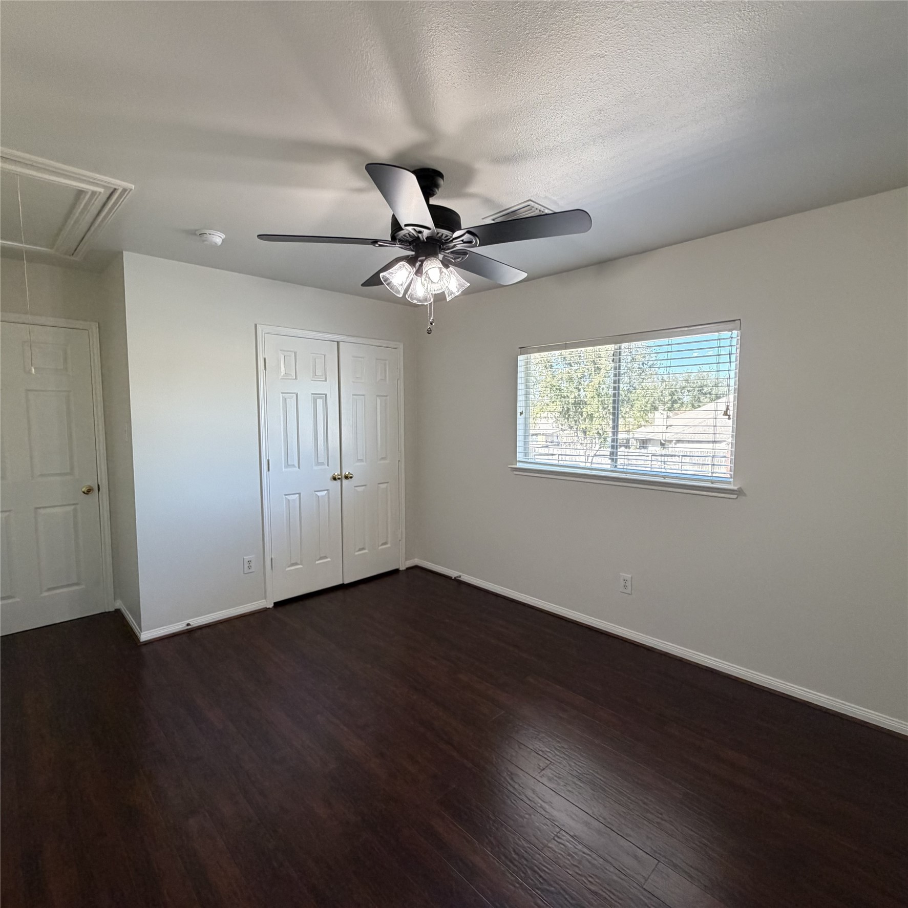 12219 Winderwick Lane Houston, TX 77066 - Photo 33 of 36 a view of an empty room with wooden floor and a ceiling fan