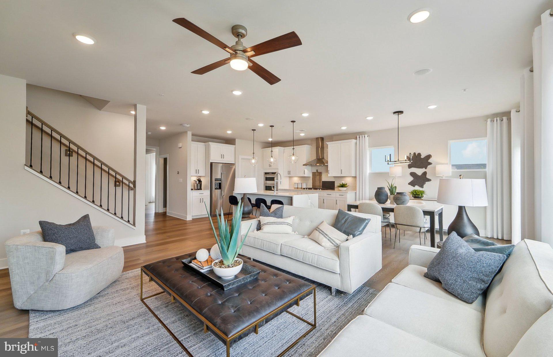 14406 Dowitcher Way Boyds, MD 20841 - Photo 14 of 52 a living room with furniture kitchen view and a chandelier