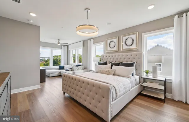 a bedroom with a bed and a large window